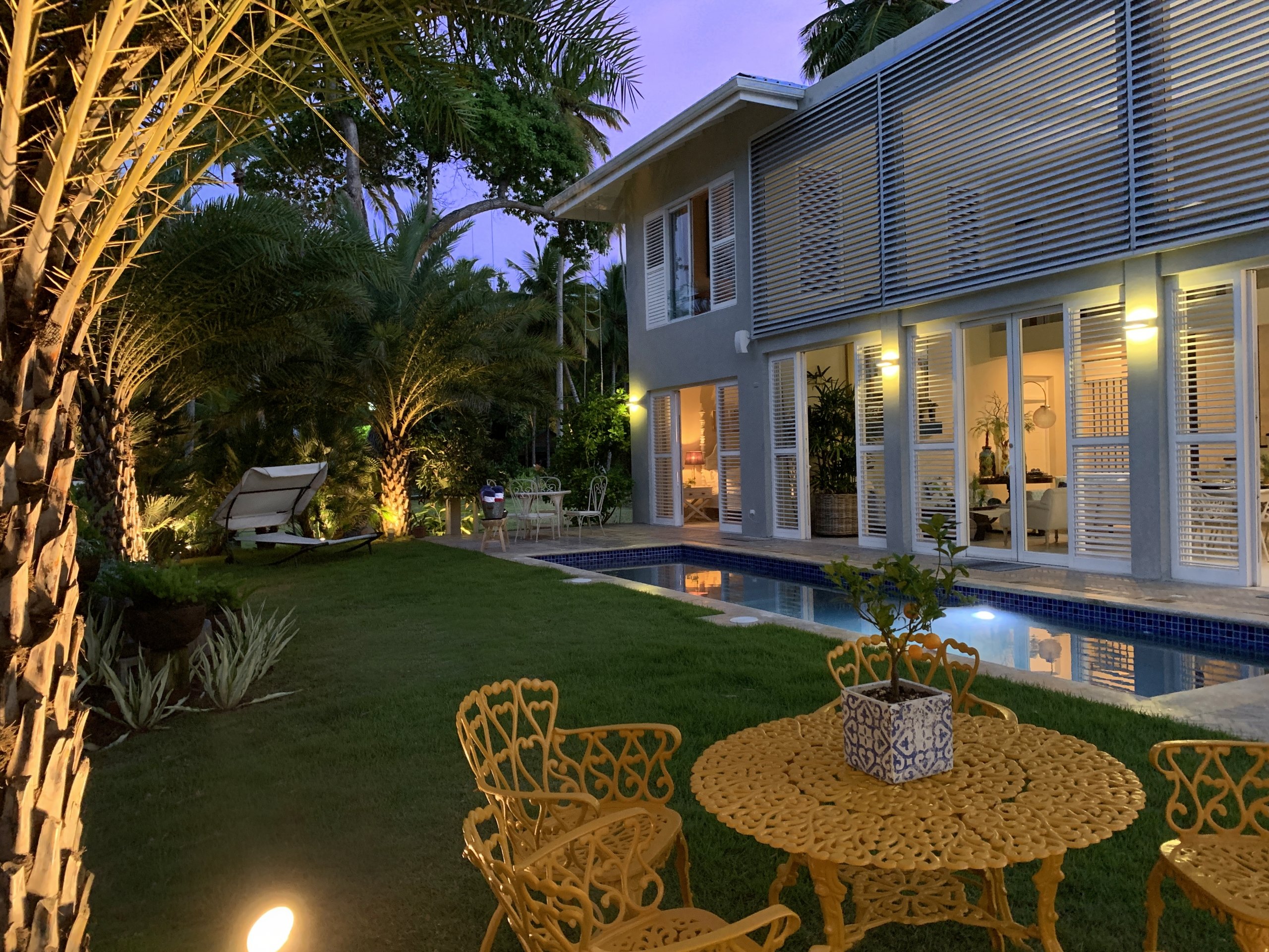 The Guest House illuminated in the tropical garden